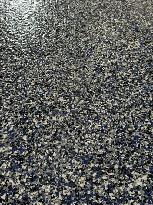 Blue, white, gray and black flake epoxy garage floor with glossy topcoat installed by IronCoat Epoxy Co. in DFW