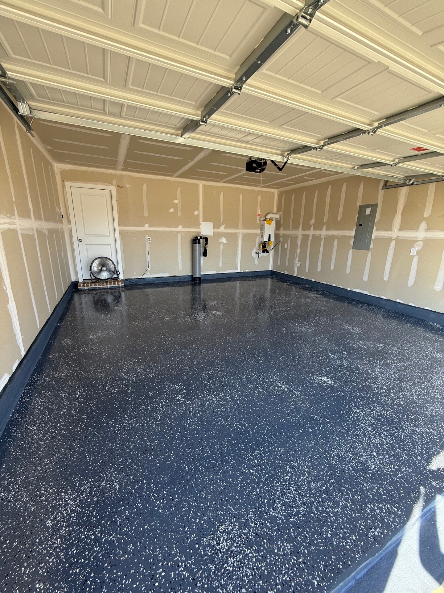 Navy blue and white flake epoxy garage floor with high-gloss topcoat installed by IronCoat Epoxy Co. in DFW