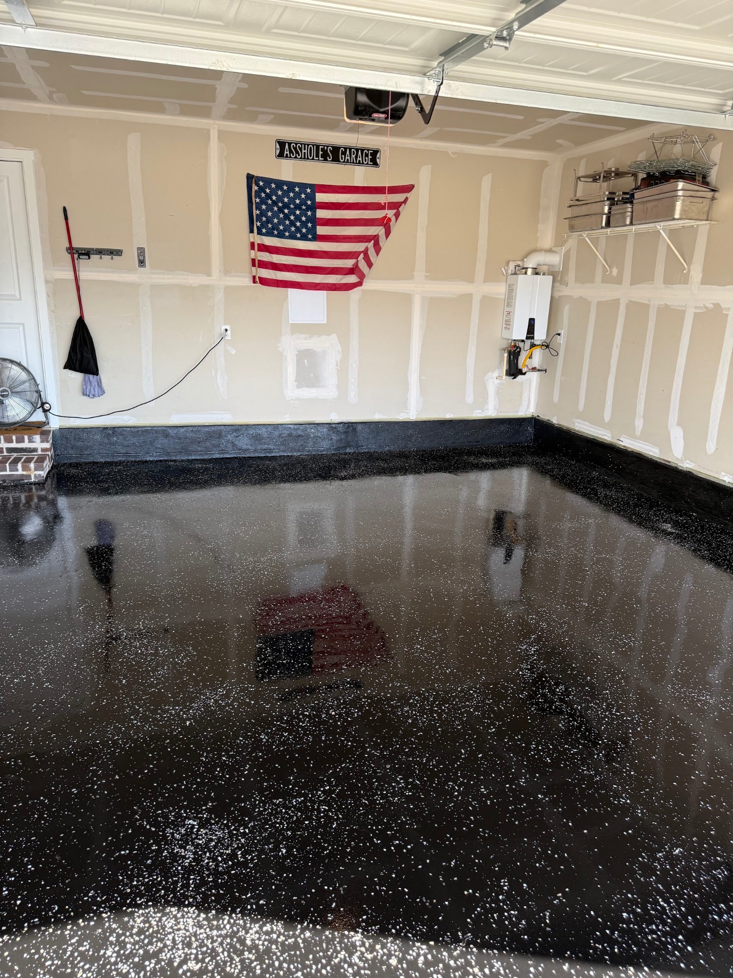 Blackout flake epoxy garage floor with white speckle and mirror-gloss finish installed by IronCoat Epoxy Co. in DFW