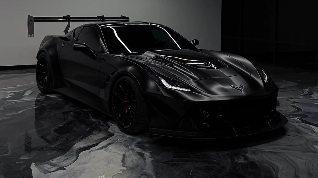 Blacked-out Corvette on a black and silver metallic epoxy showroom floor installed by IronCoat Epoxy Co. in DFW